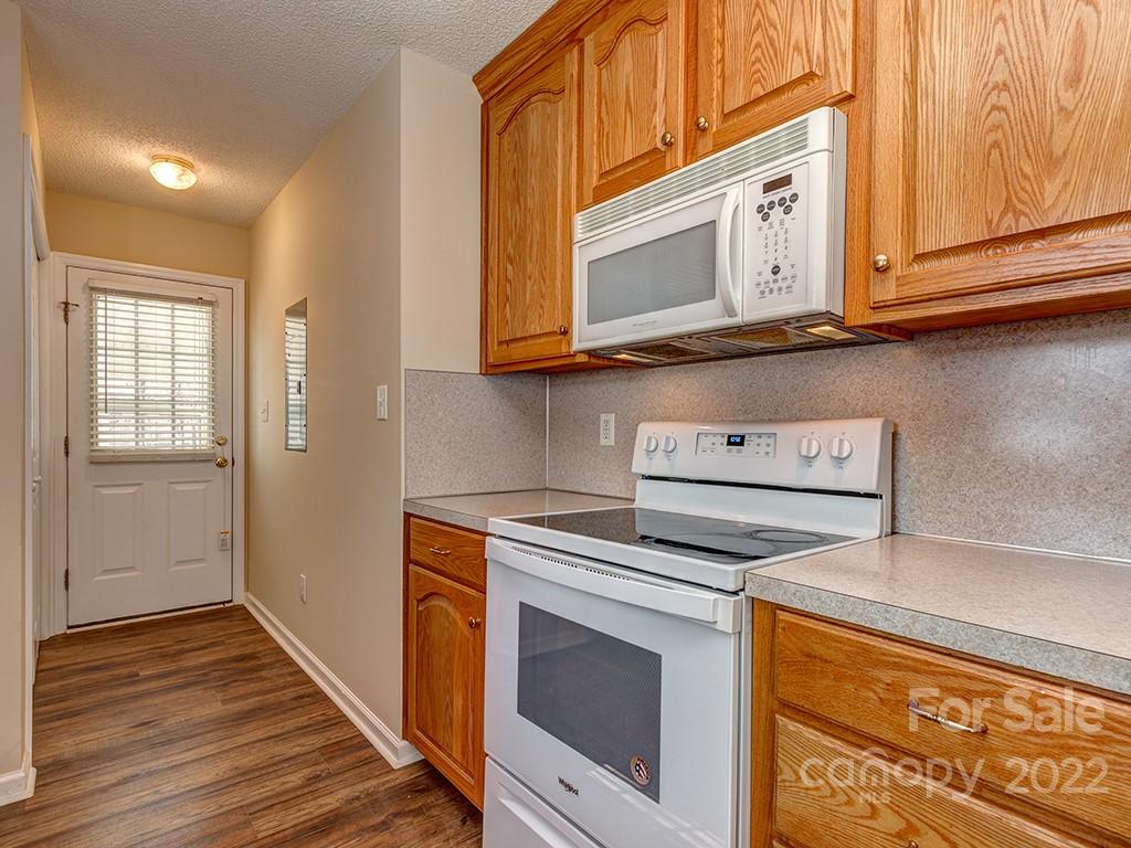 3488 State Rd S-29-330 Lancaster, SC 29720 - Photo 11 of 25 a kitchen with wooden cabinets and a stove top oven