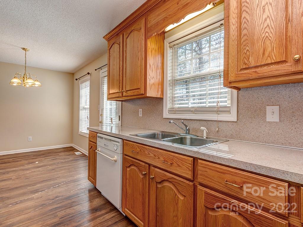 3488 State Rd S-29-330 Lancaster, SC 29720 - Photo 12 of 25 a kitchen with granite countertop wooden cabinets a sink and dishwasher