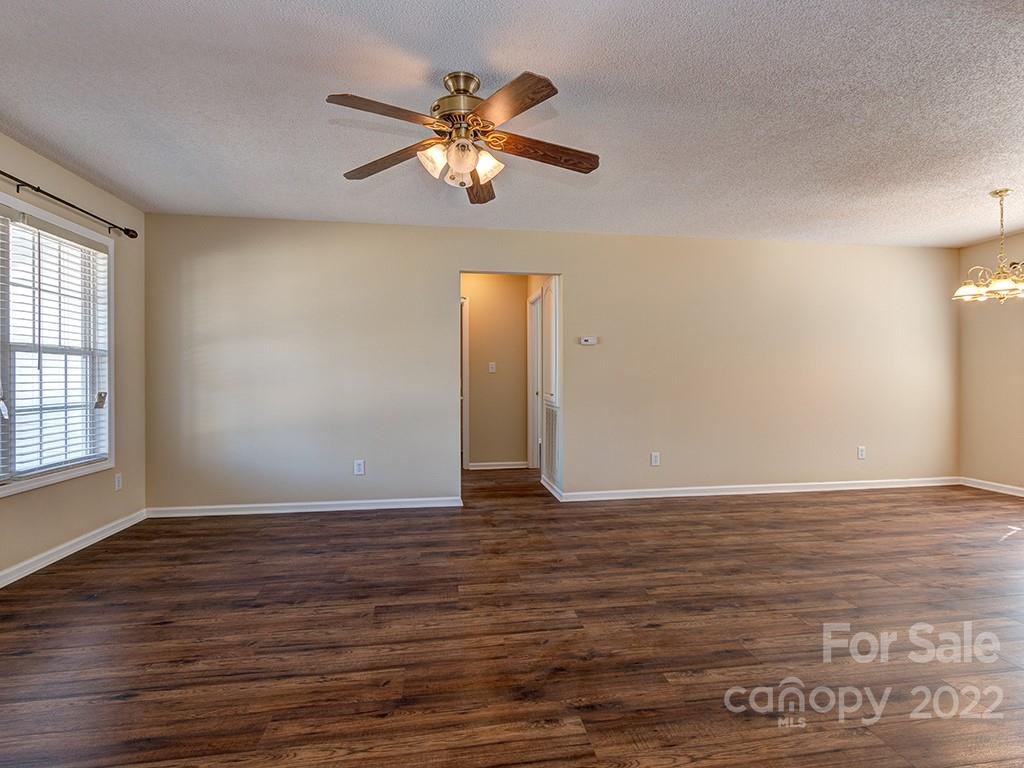 3488 State Rd S-29-330 Lancaster, SC 29720 - Photo 8 of 25 a view of an empty room with wooden floor and a chandelier