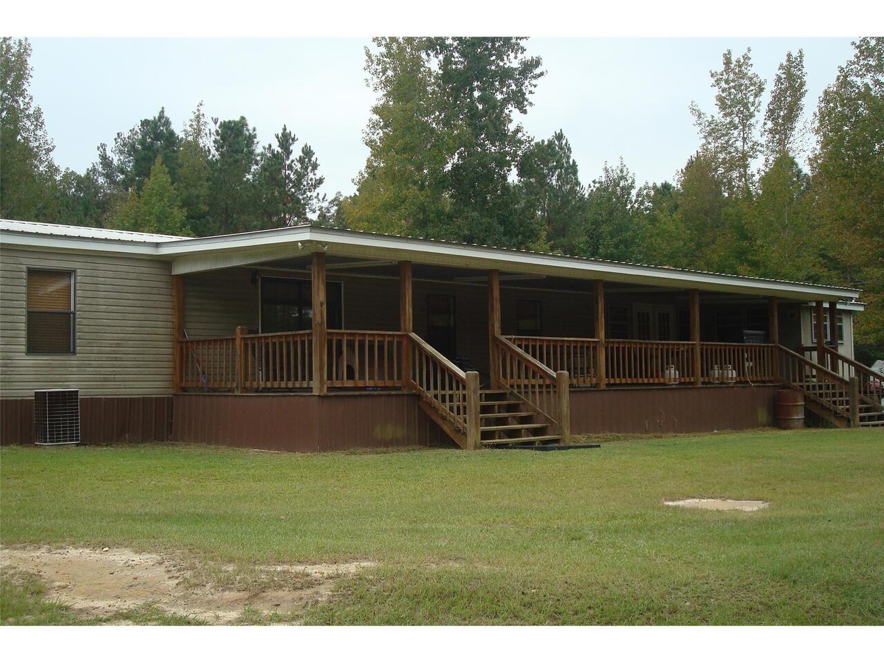 8282 Pinetucky Road Kite, GA 31049 - Photo 1 of 1 a view of an house with backyard space and deck
