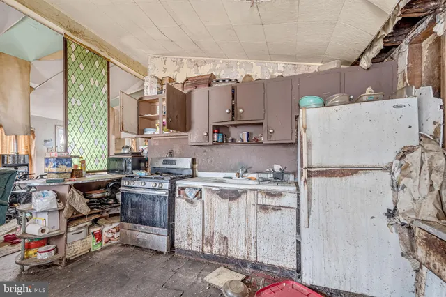 a kitchen with a sink a stove and a refrigerator
