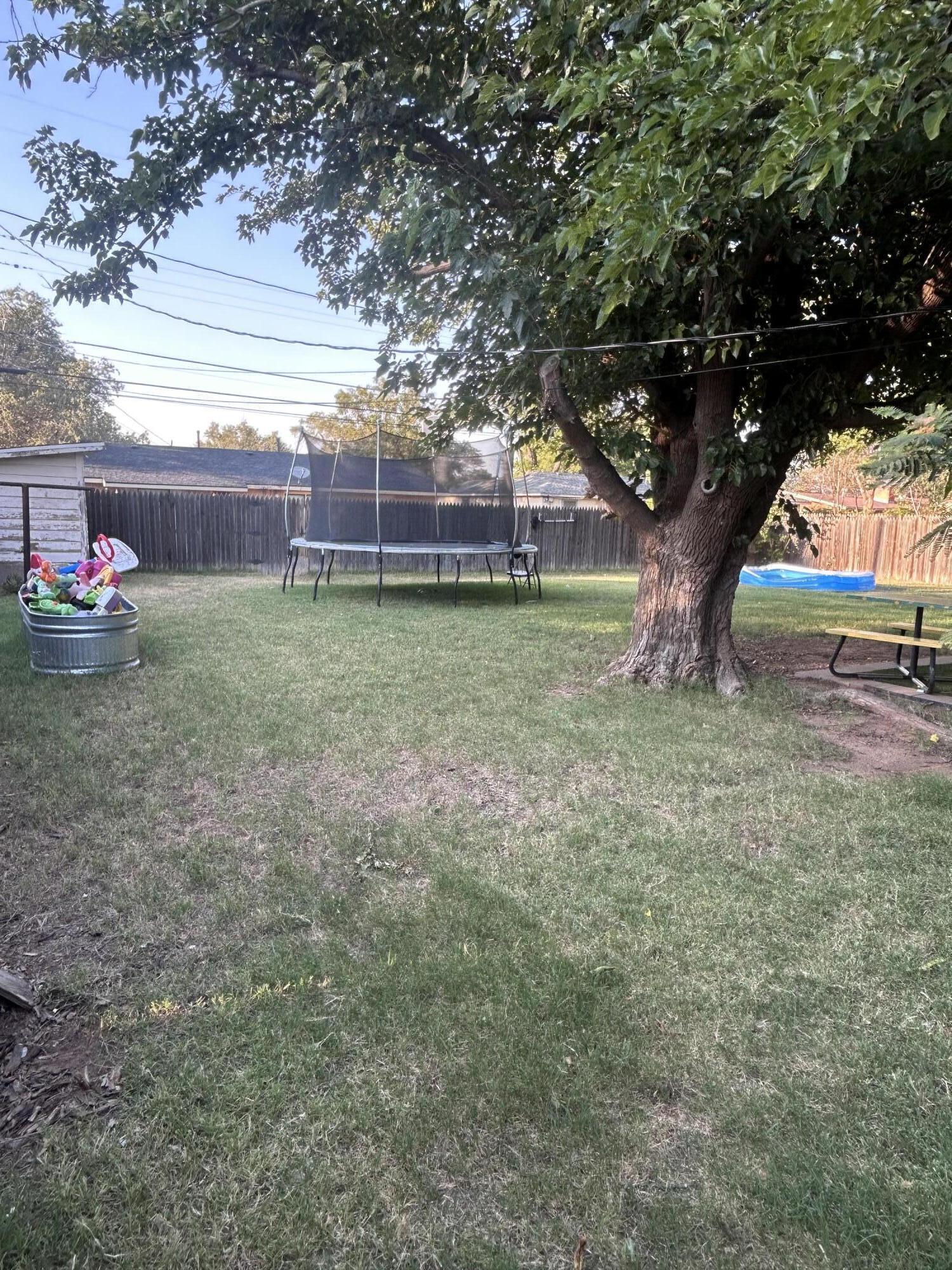 3808 37th Street Lubbock, TX 79413 - Photo 15 of 19 a view of yard with tree and wooden fence