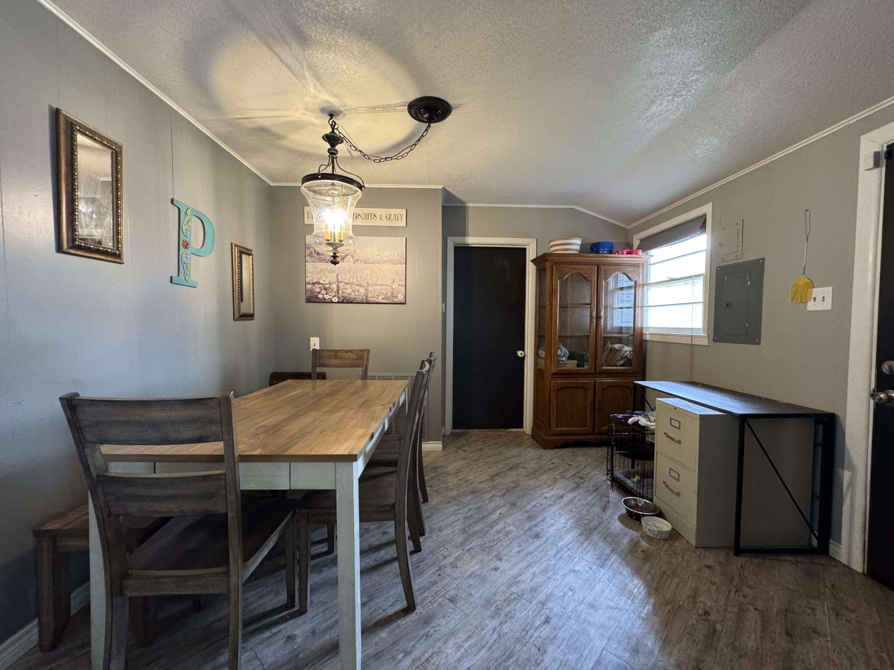 3808 37th Street Lubbock, TX 79413 - Photo 4 of 19 a view of a dining room with furniture and wooden floor
