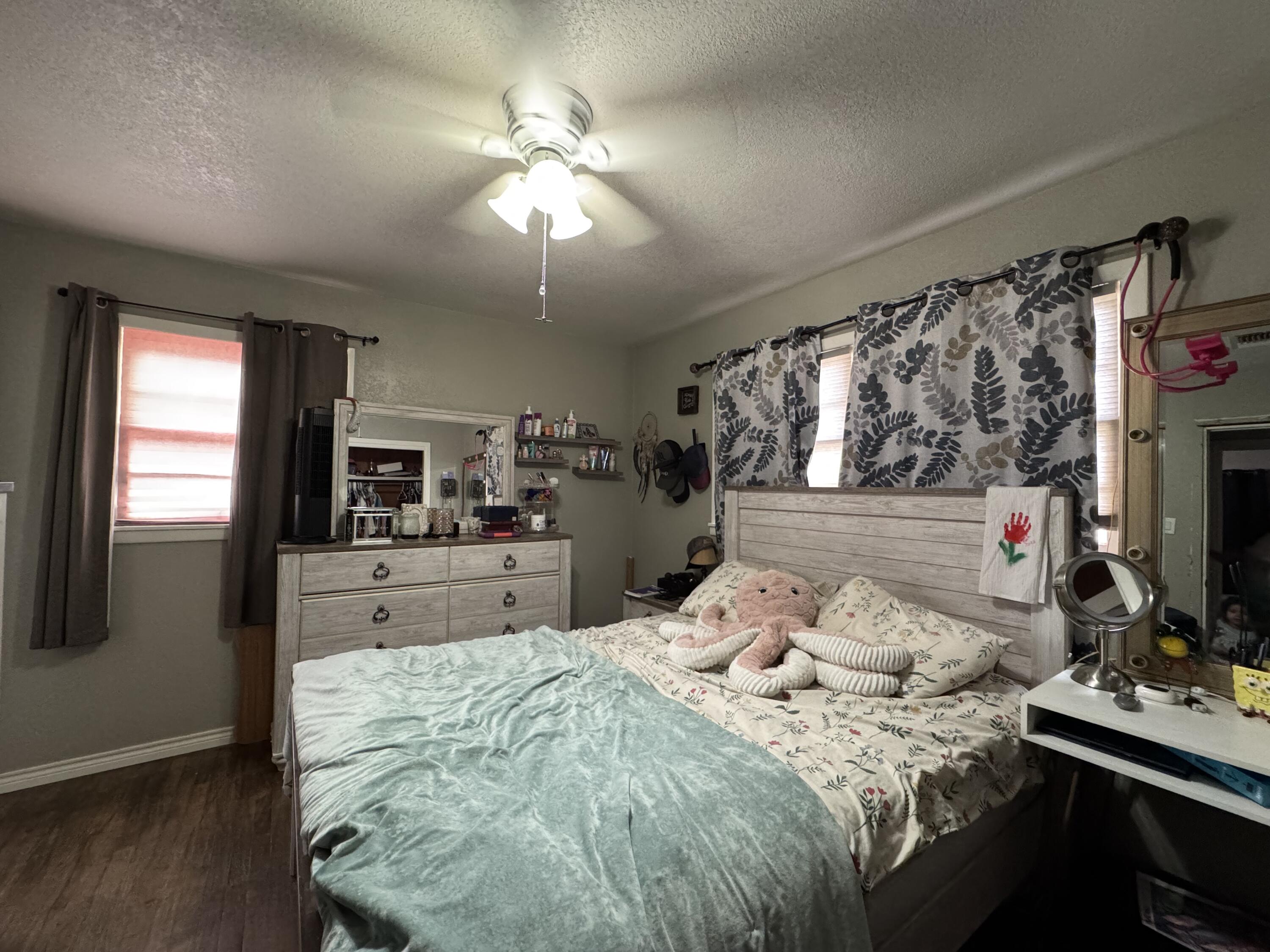 3808 37th Street Lubbock, TX 79413 - Photo 9 of 19 a bedroom with a bed and a flat screen tv