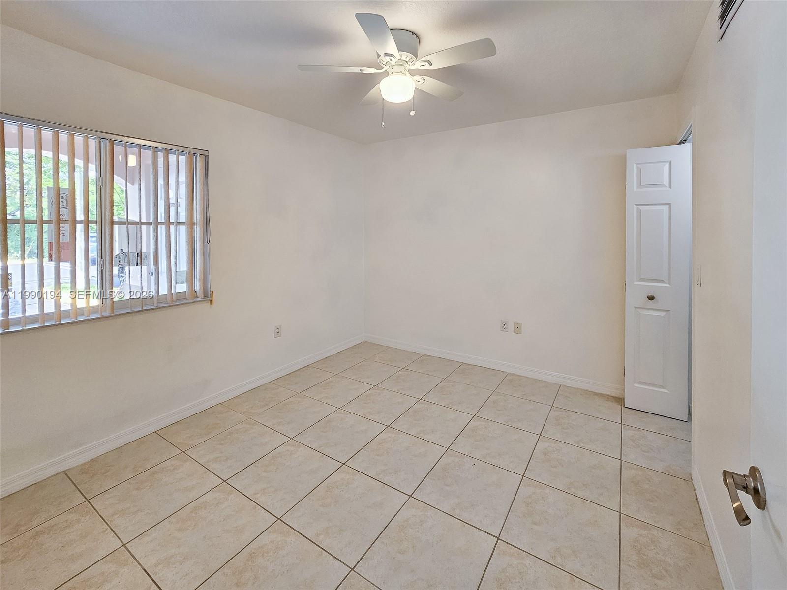 2651 Southeast 12th Road, Unit 105 Homestead, FL 33035 - Photo 17 of 24 a view of an empty room with a window