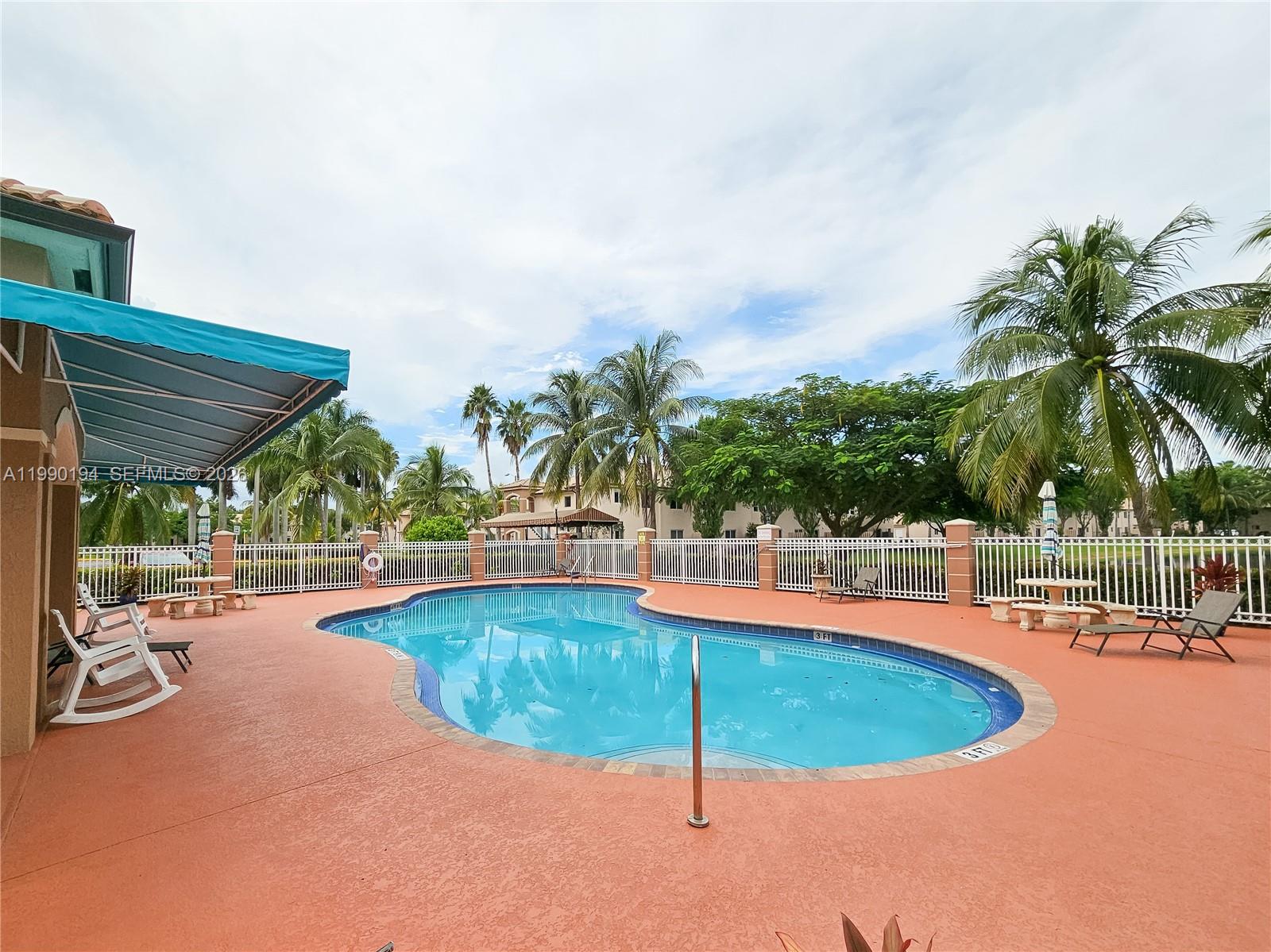 2651 Southeast 12th Road, Unit 105 Homestead, FL 33035 - Photo 24 of 24 a view of a swimming pool with lounge chairs