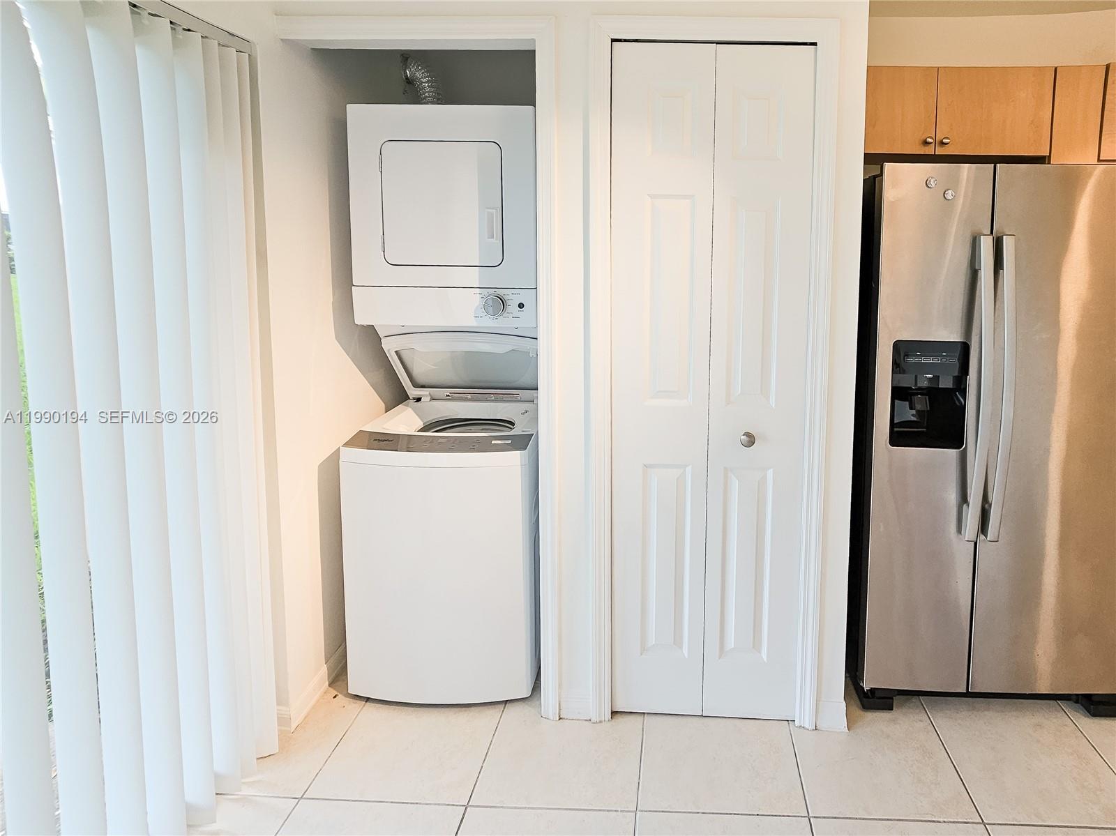 2651 Southeast 12th Road, Unit 105 Homestead, FL 33035 - Photo 4 of 24 a utility room with wooden floor washer and dryer