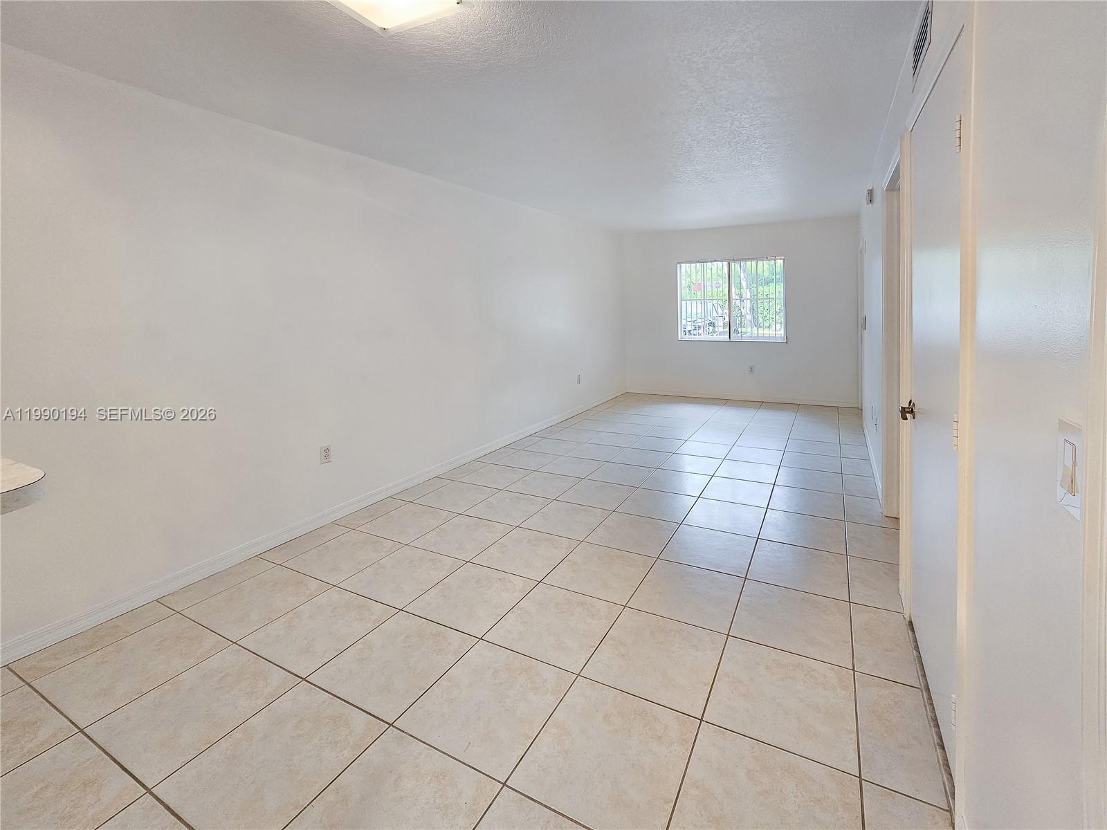 2651 Southeast 12th Road, Unit 105 Homestead, FL 33035 - Photo 9 of 24 a view of an empty room and window