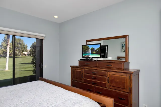 a room with a bed and a television