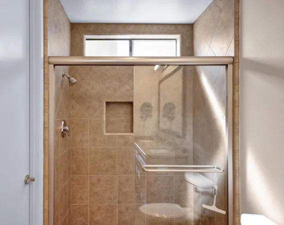 a bathroom with a glass shower door