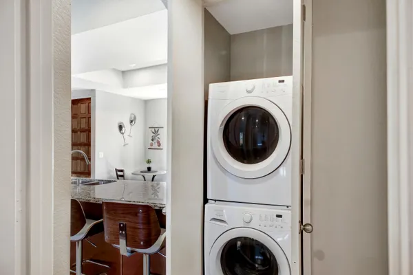 a view of a hallway with washer and dryer