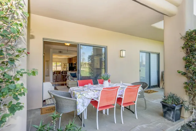 a dining room with furniture and potted plants