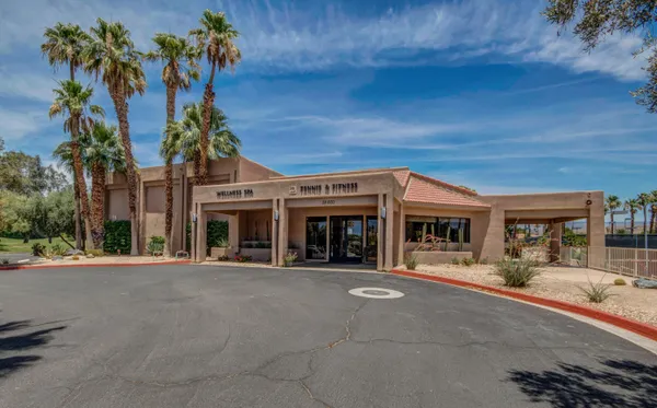 front view of a building with potted plants