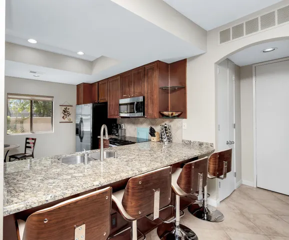 a kitchen with kitchen island granite countertop a sink and counter space