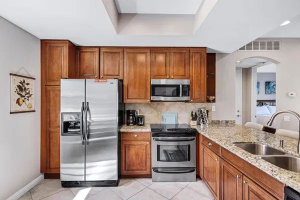 a kitchen with stainless steel appliances a refrigerator stove and sink