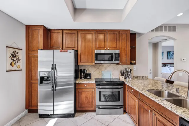 a kitchen with stainless steel appliances a refrigerator stove and sink