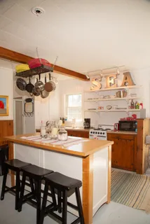 a kitchen with a table chairs stove and cabinets