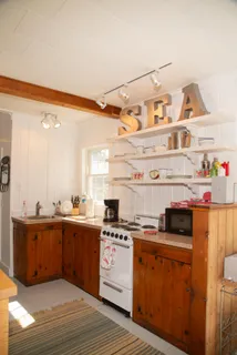 a kitchen with a cabinets and wooden floor