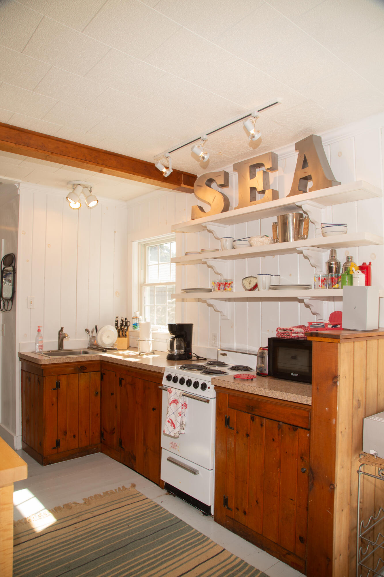 10 Wixon Road Dennis Port, MA 02639 - Photo 12 of 25 a kitchen with a cabinets and wooden floor