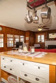 a view of a living room and kitchen space with a chandelier