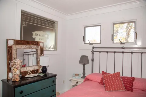 a bedroom with furniture and a window