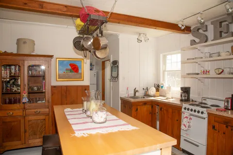 a kitchen with a sink stove and cabinets