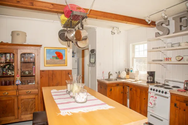 a kitchen with a sink stove and cabinets