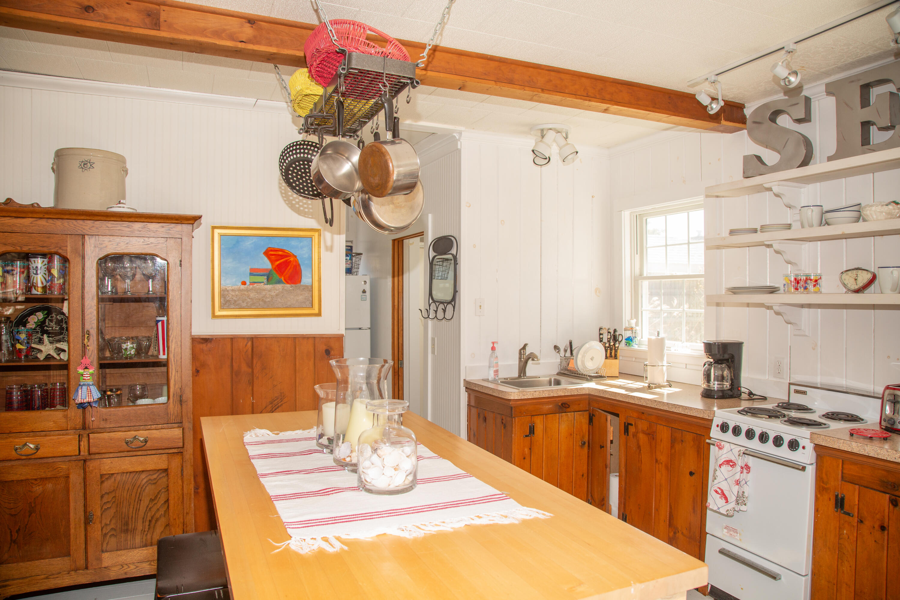 10 Wixon Road Dennis Port, MA 02639 - Photo 22 of 25 a kitchen with a sink stove and cabinets