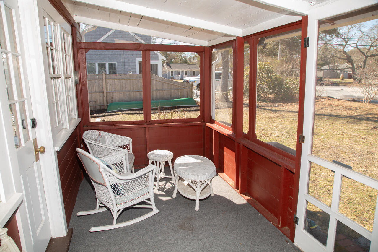 10 Wixon Road Dennis Port, MA 02639 - Photo 25 of 25 a room with a chair and large windows