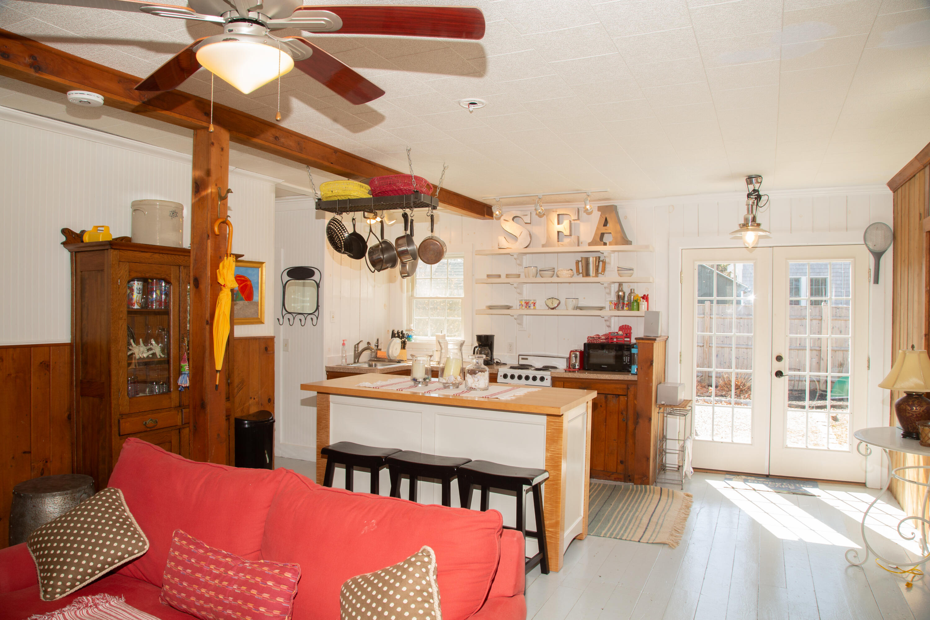 10 Wixon Road Dennis Port, MA 02639 - Photo 10 of 25 a kitchen with stainless steel appliances kitchen island granite countertop a table chairs in it and wooden floors
