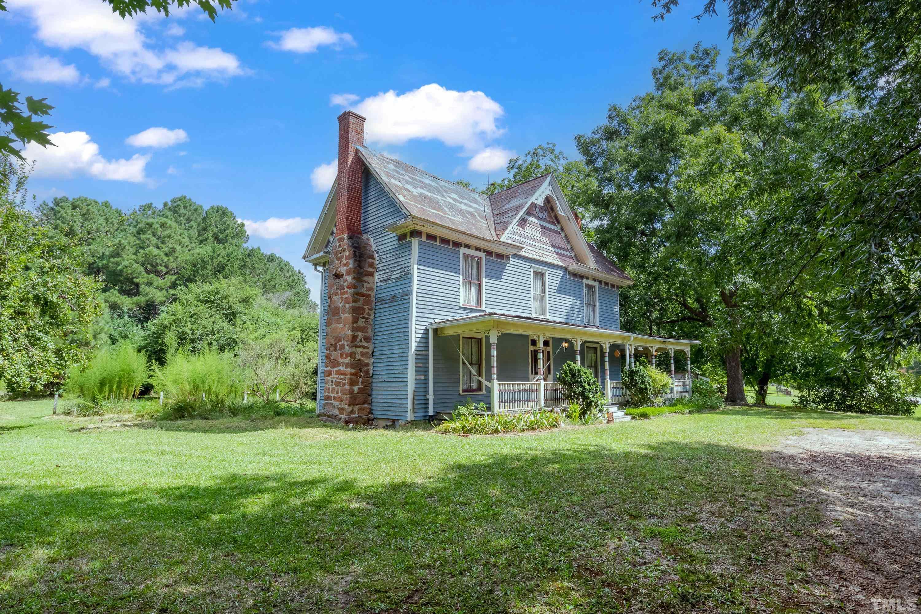 3614 Carpenter Pond Road Durham, NC 27703 - Photo 2 of 57 a view of a house with backyard and a tree