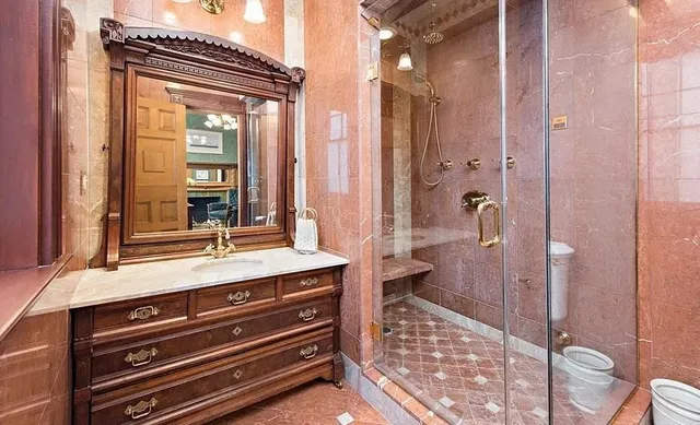 a bathroom with a sink a mirror and a shower