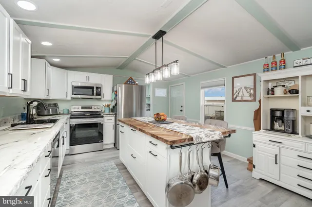 a kitchen with a stove a sink and a refrigerator
