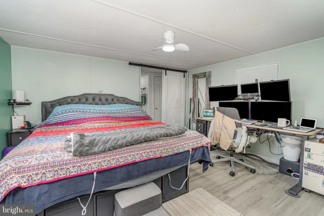 a bedroom with a bed and a desk in it