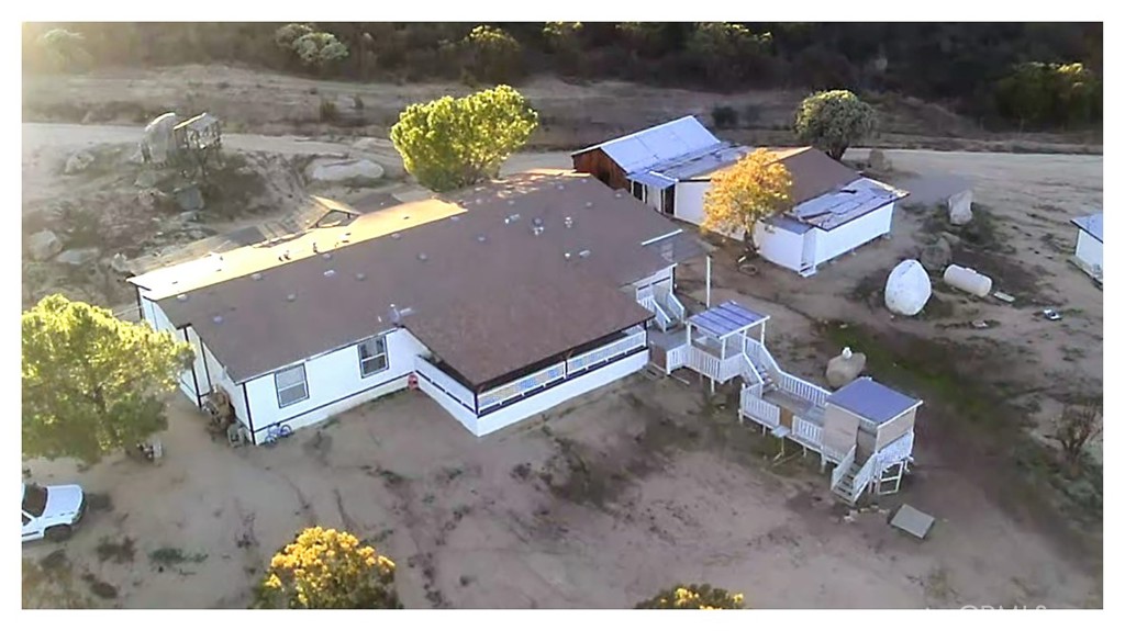 an aerial view of a house with garden space and sitting space