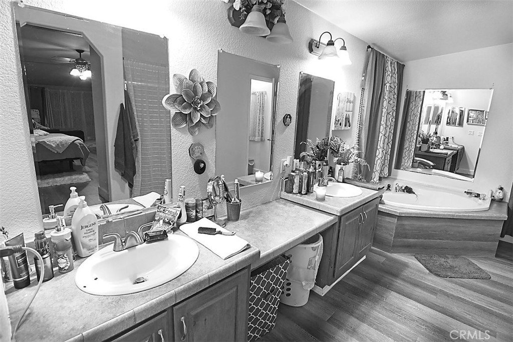 51490 Forest Boundary Road Anza, CA 92539 - Photo 15 of 32 a bathroom with double vanity sinks double vanity tub and a mirror