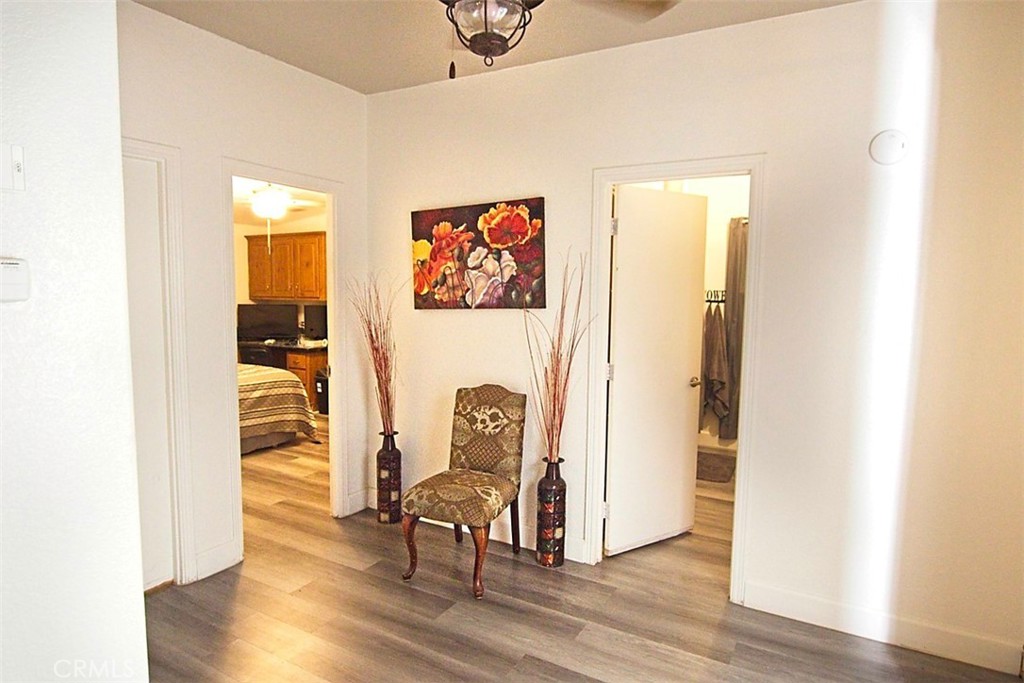 51490 Forest Boundary Road Anza, CA 92539 - Photo 16 of 32 a view of a hallway with wooden floor table and chairs