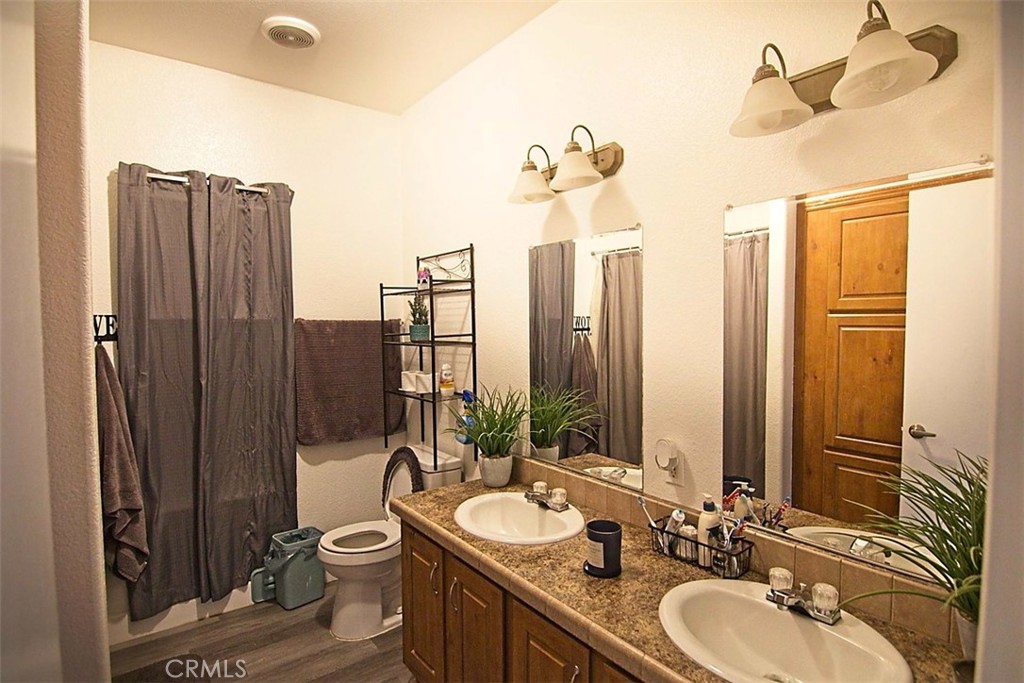 51490 Forest Boundary Road Anza, CA 92539 - Photo 22 of 32 a bathroom with a double vanity sink and mirror