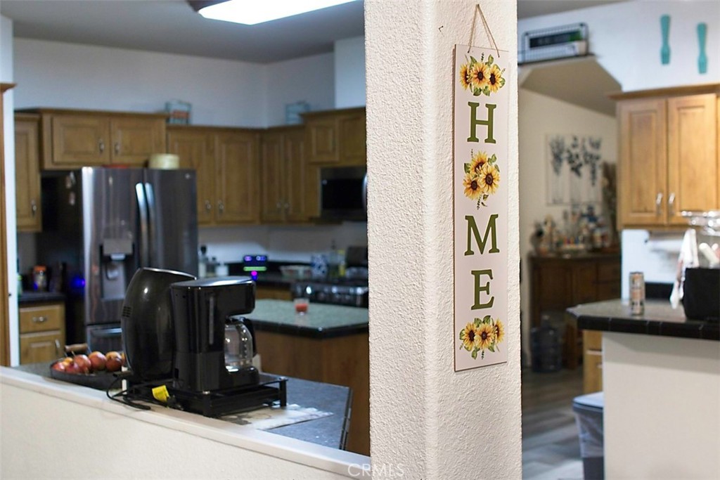 51490 Forest Boundary Road Anza, CA 92539 - Photo 5 of 32 a kitchen with a refrigerator and a stove top oven