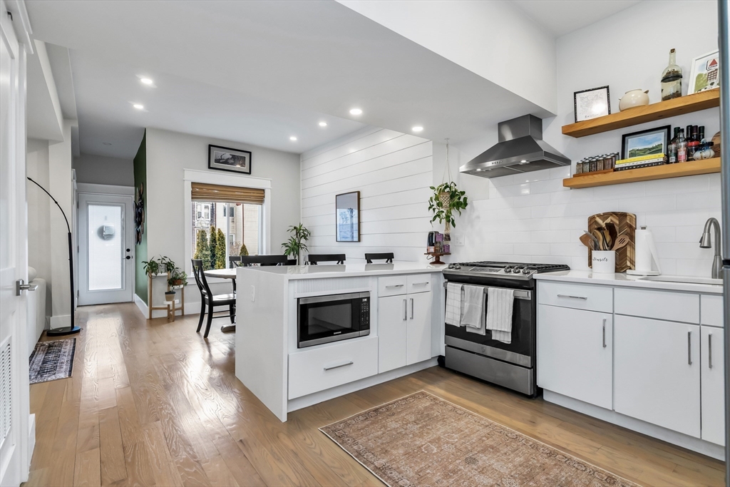 a view of kitchen with sink and wooden floor