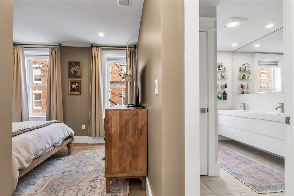 215 Maverick Street, Unit 2 Boston, MA 02128 - Photo 13 of 22 a spacious bedroom with a bed and a couch