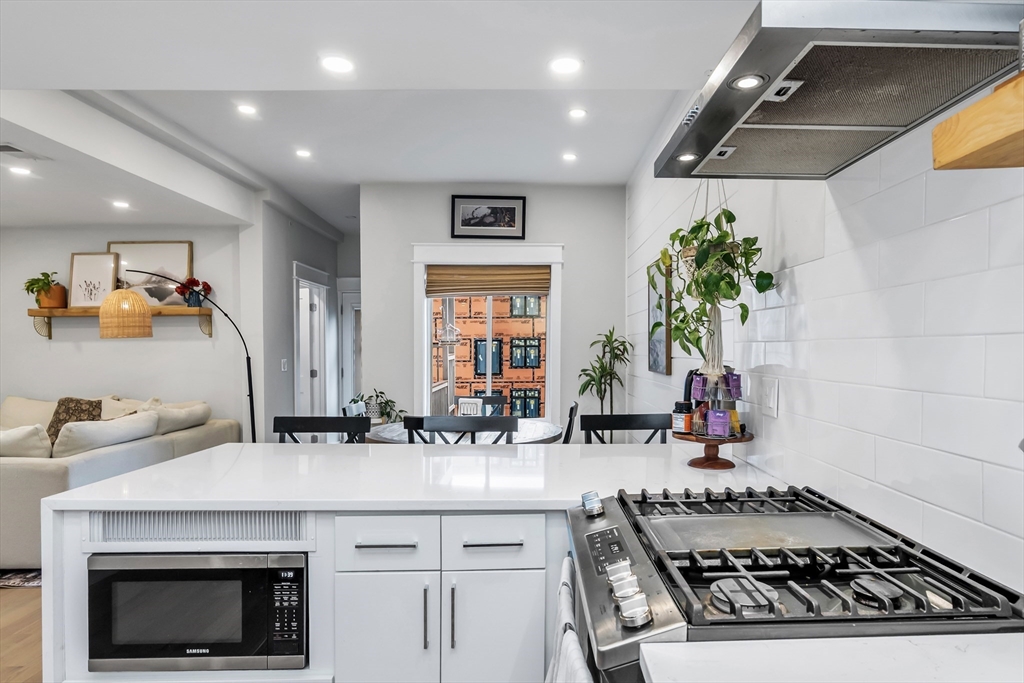 215 Maverick Street, Unit 2 Boston, MA 02128 - Photo 5 of 22 a kitchen with a sink and stove