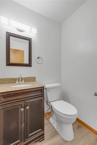 a bathroom with a toilet a sink and mirror