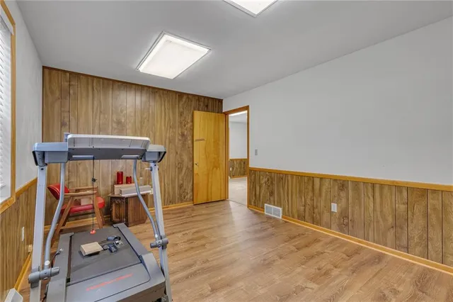 a view of a room with wooden floor water heater and windows