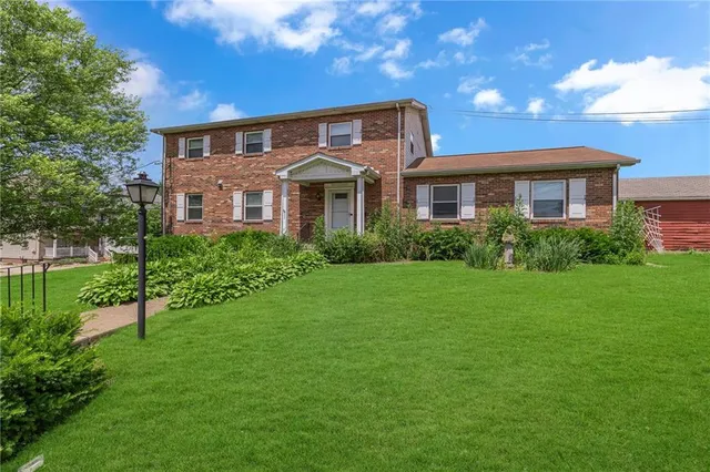 a front view of a house with a yard