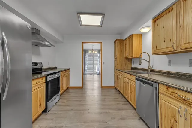 a kitchen with granite countertop a sink and stainless steel appliances