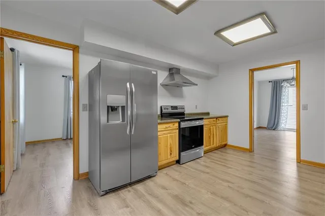 a kitchen with a refrigerator and a sink