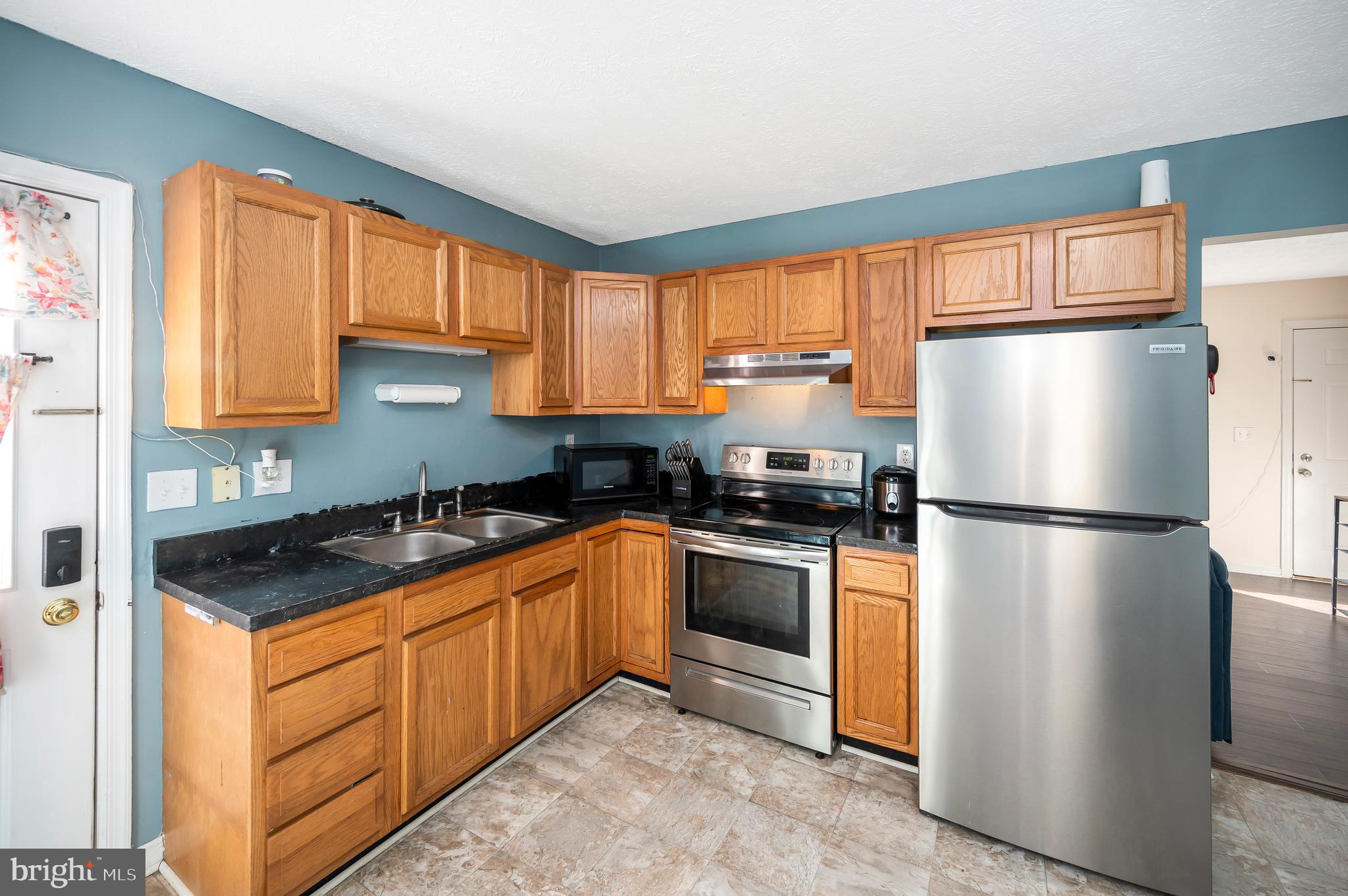 9577 Roys Lane Culpeper, VA 22701 - Photo 11 of 42 a kitchen with stainless steel appliances granite countertop a refrigerator sink and cabinets