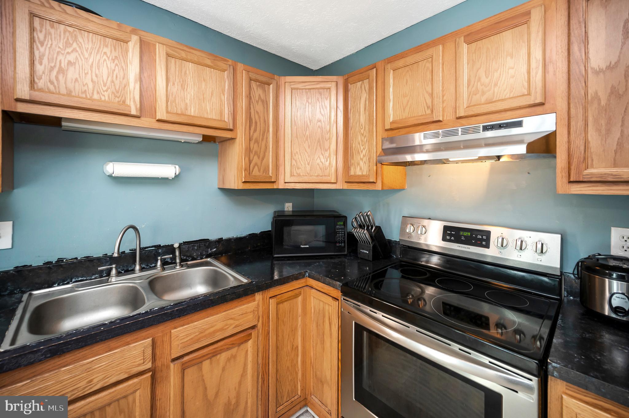 9577 Roys Lane Culpeper, VA 22701 - Photo 12 of 41 a kitchen with granite countertop cabinets stainless steel appliances and a sink
