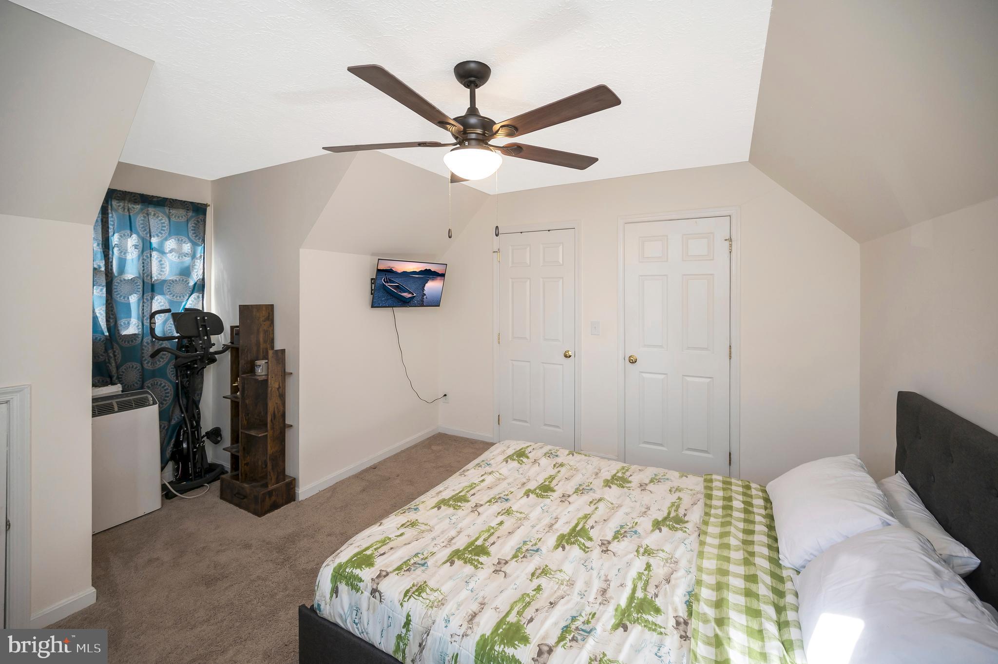 9577 Roys Lane Culpeper, VA 22701 - Photo 26 of 41 a bedroom with a bed and a chandelier